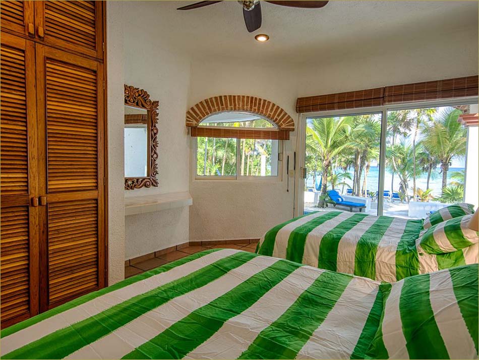 Lower level third bedroom encludes a private bathroom and pool side patio overlooking beach.