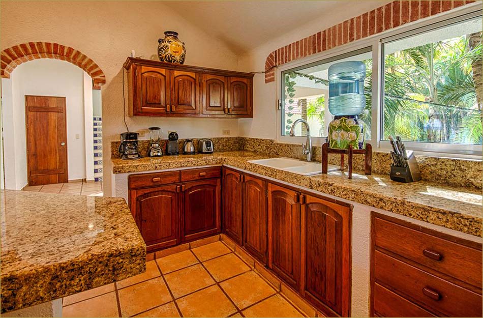 Gourmet kitchen with profession appliances, granite countertops and stone tile floors.